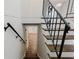 Elegant staircase featuring dark wood steps, decorative black iron railing, and a view to the foyer at 2976 Bay Berry Sw Dr, Marietta, GA 30008