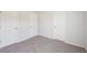A bedroom with carpeted floors and neutral walls at 11831 Rizvan Pl, Covington, GA 30014