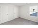 An inviting bedroom showcasing two doors and large window, providing natural light and ample space at 11831 Rizvan Pl, Covington, GA 30014
