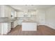Well-lit kitchen with white cabinets, granite countertops, tile backsplash, stainless sink, pendant lights, island and pantry at 11831 Rizvan Pl, Covington, GA 30014