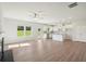 Open-concept living room and kitchen boasting bright white cabinets, granite countertops, and a center island at 11831 Rizvan Pl, Covington, GA 30014
