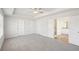 Spacious main bedroom features carpet, a ceiling fan, and an ensuite bath at 11831 Rizvan Pl, Covington, GA 30014