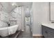 Bright bathroom with marble tile, a glass shower, tub, and access to double sink vanity at 199 Racine Sw St, Atlanta, GA 30314