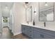 Hallway with modern bathroom featuring double vanities and stylish lighting fixtures at 199 Racine Sw St, Atlanta, GA 30314