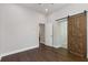 Hardwood floor bedroom featuring a sliding barn door and neutral paint, creating a modern and stylish space at 199 Racine Sw St, Atlanta, GA 30314