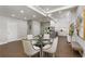Bright dining area with glass table, seating, and hardwood floors, leading to a modern kitchen at 199 Racine Sw St, Atlanta, GA 30314