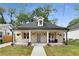 Charming home exterior with covered porch, stone facade, and manicured landscaping at 199 Racine Sw St, Atlanta, GA 30314