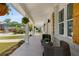Inviting front porch with wicker seating and hanging planters at 199 Racine Sw St, Atlanta, GA 30314