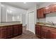 Modern kitchen with granite countertops and dark wood cabinets at 2479 Peachtree Rd # 101, Atlanta, GA 30324
