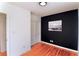 Bedroom with hardwood floors, black accent wall, and double doors at 2546 Glendale Se Cir, Smyrna, GA 30080