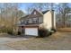 Two-story house with a metal roof, brick facade, and a two-car garage at 111 Iverson Pl, Temple, GA 30179