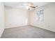 Bedroom with carpet flooring, ceiling fan and window with diamond pattern at 4147 Azalea Ct, Snellville, GA 30039