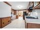 Kitchen with wood cabinets, tile flooring, and view to the Gathering room at 4147 Azalea Ct, Snellville, GA 30039