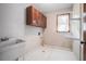Laundry room with a sink, cabinets and hexagon tile floor at 4147 Azalea Ct, Snellville, GA 30039
