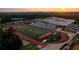 Aerial view of school and the football field with the stadium and track at 502 Winston Croft Cir # 53, Johns Creek, GA 30022