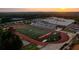 Aerial view of school and the football field with the stadium and track at 502 Winston Croft Cir # 53, Johns Creek, GA 30022