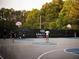 A well-lit outdoor basketball court with players, showcasing a recreational amenity in a community at 502 Winston Croft Cir # 53, Johns Creek, GA 30022
