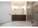Bathroom features double vanity with framed mirrors and a glass enclosed tiled shower at 502 Winston Croft Cir # 53, Johns Creek, GA 30022