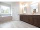 Bright bathroom with double vanity, framed mirrors, a soaking tub, and a large window at 502 Winston Croft Cir # 53, Johns Creek, GA 30022