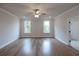 Spacious bedroom with hardwood floors, natural light, and neutral paint at 502 Winston Croft Cir # 53, Johns Creek, GA 30022