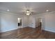 Spacious bedroom featuring hardwood floors, a ceiling fan, and ensuite bathroom access at 502 Winston Croft Cir # 53, Johns Creek, GA 30022