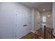Upstairs hallway with hardwood floors and white doors leading to the bedrooms and baths at 502 Winston Croft Cir # 53, Johns Creek, GA 30022
