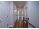 Long hallway with hardwood floors, white doors and trim, and neutral walls at 502 Winston Croft Cir # 53, Johns Creek, GA 30022