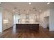 A modern kitchen featuring a spacious center island, white cabinets, and designer globe pendant lights at 502 Winston Croft Cir # 53, Johns Creek, GA 30022