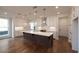 A modern kitchen featuring a spacious center island, white cabinets, and designer globe pendant lights at 502 Winston Croft Cir # 53, Johns Creek, GA 30022