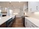 Kitchen featuring a large island with white countertops and modern appliances at 502 Winston Croft Cir # 53, Johns Creek, GA 30022
