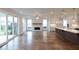 Bright open concept living room showcases hardwood floors, a stone fireplace, and sliding doors to the patio at 502 Winston Croft Cir # 53, Johns Creek, GA 30022