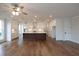 Open living space leads into a spacious kitchen with island, stainless appliances, and abundant white cabinetry at 502 Winston Croft Cir # 53, Johns Creek, GA 30022