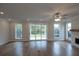 Spacious living room featuring hardwood floors, fireplace, sliding doors to backyard at 502 Winston Croft Cir # 53, Johns Creek, GA 30022