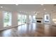 Bright living room featuring hardwood floors, fireplace, sliding doors to the backyard at 502 Winston Croft Cir # 53, Johns Creek, GA 30022