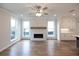 Living area with fireplace, hardwood floors, lots of natural light from the many windows and built-in shelving at 502 Winston Croft Cir # 53, Johns Creek, GA 30022