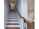 Wooden staircase features wood and white risers and decorative bannister leading upstairs at 502 Winston Croft Cir # 53, Johns Creek, GA 30022