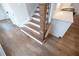 Close-up on new staircase with hardwood steps, painted risers, and decorative post at 502 Winston Croft Cir # 53, Johns Creek, GA 30022