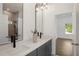 Modern bathroom with dual vanity, gray cabinets and quartz countertops at 1432 Mims Sw St, Atlanta, GA 30314