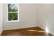 Well-lit bedroom featuring hardwood floors and a window at 1432 Mims Sw St, Atlanta, GA 30314