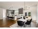 Modern kitchen and dining area with open concept, dark hardwood floors and modern lighting at 1432 Mims Sw St, Atlanta, GA 30314