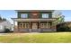 Two-story house with green and brown siding, a large front porch, and a well-manicured lawn at 1432 Mims Sw St, Atlanta, GA 30314