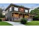 Charming two-story home featuring a welcoming porch, complemented by a well-manicured lawn and a concrete driveway at 1432 Mims Sw St, Atlanta, GA 30314