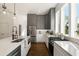 Modern kitchen with gray and white cabinets, quartz countertops, and stainless steel appliances at 1432 Mims Sw St, Atlanta, GA 30314