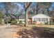 Charming one-story house with red door, mature tree, and spacious yard at 1603 Hollyhock Ter, Decatur, GA 30032