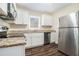 Modern kitchen with white cabinets, granite counters, and stainless steel appliances at 1603 Hollyhock Ter, Decatur, GA 30032