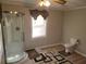 Bathroom with a large shower, toilet and updated flooring at 2455 Lake Harbin Rd, Morrow, GA 30260