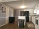 Kitchen features white cabinets, black appliances, and an island at 2455 Lake Harbin Rd, Morrow, GA 30260