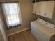Bright laundry room with washer, dryer, and cabinets at 2455 Lake Harbin Rd, Morrow, GA 30260