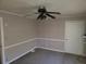 Spacious living room featuring a ceiling fan and neutral color palette at 2455 Lake Harbin Rd, Morrow, GA 30260