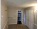 Spacious living room with doors leading to backyard and additional rooms at 2455 Lake Harbin Rd, Morrow, GA 30260